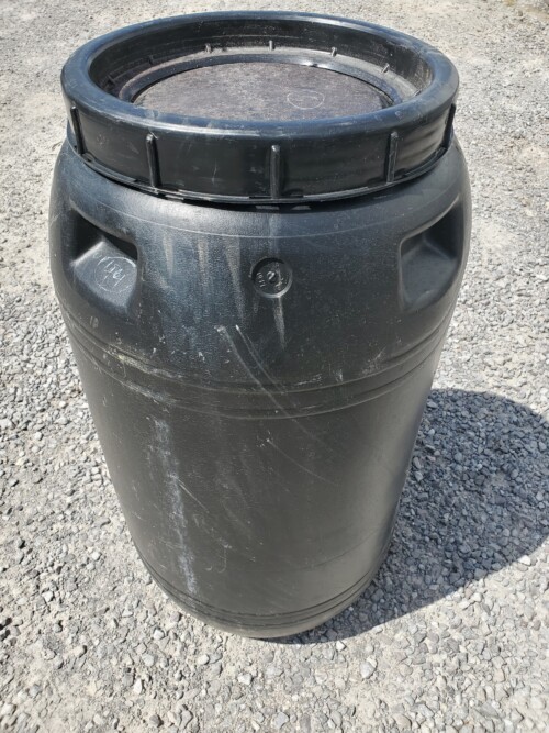 open top plastic barrel with lid grey background