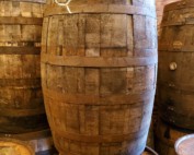 jim beam wooden barrel with barrels in background