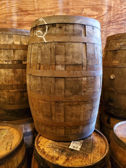 jim beam wooden barrel with barrels in background