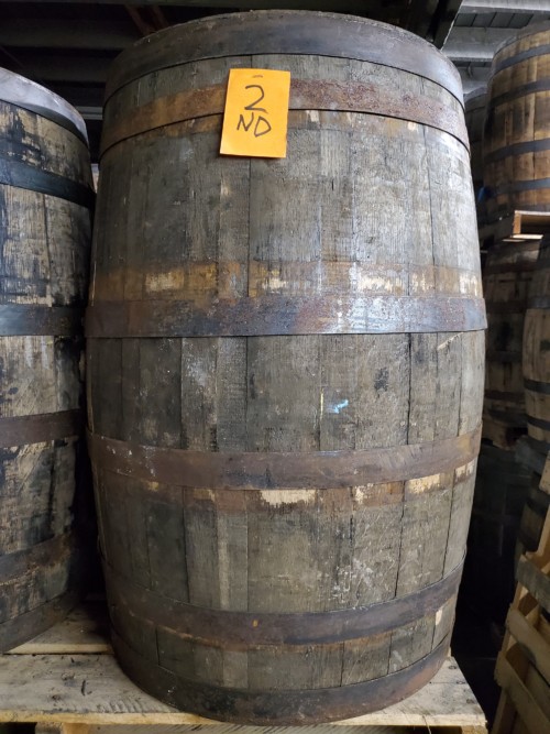 old stock wooden barrels on pallet with barrels in background