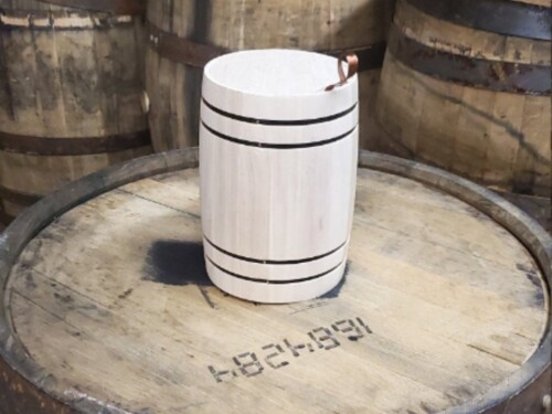 small wooden barrel on large wooden barrel with wooden barrels in the background